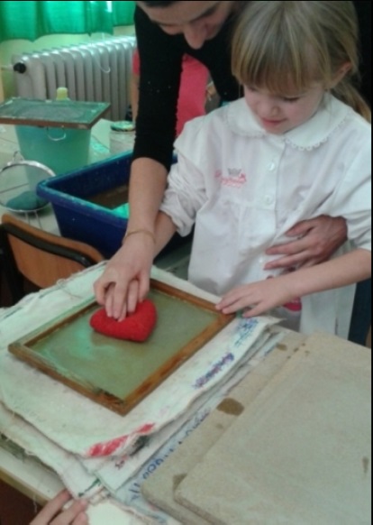 Vittoria, con la spugna, assorbe l'acqua dal setaccio.