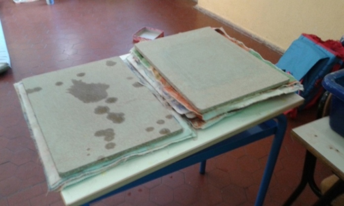 I nuovi fogli di carta bagnata vengono pressati con tavolette di legno.